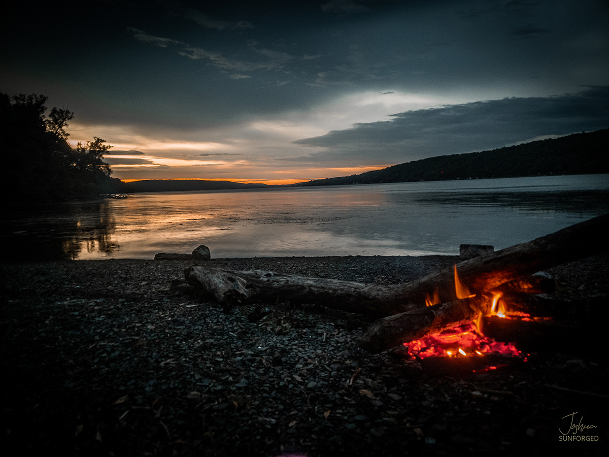 lake otiscp embers fading as the sun sets in NY late summer scene